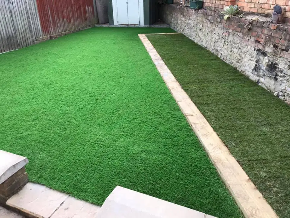 garden area with both real turf and artificial grass with a sleeper border to seperate them.